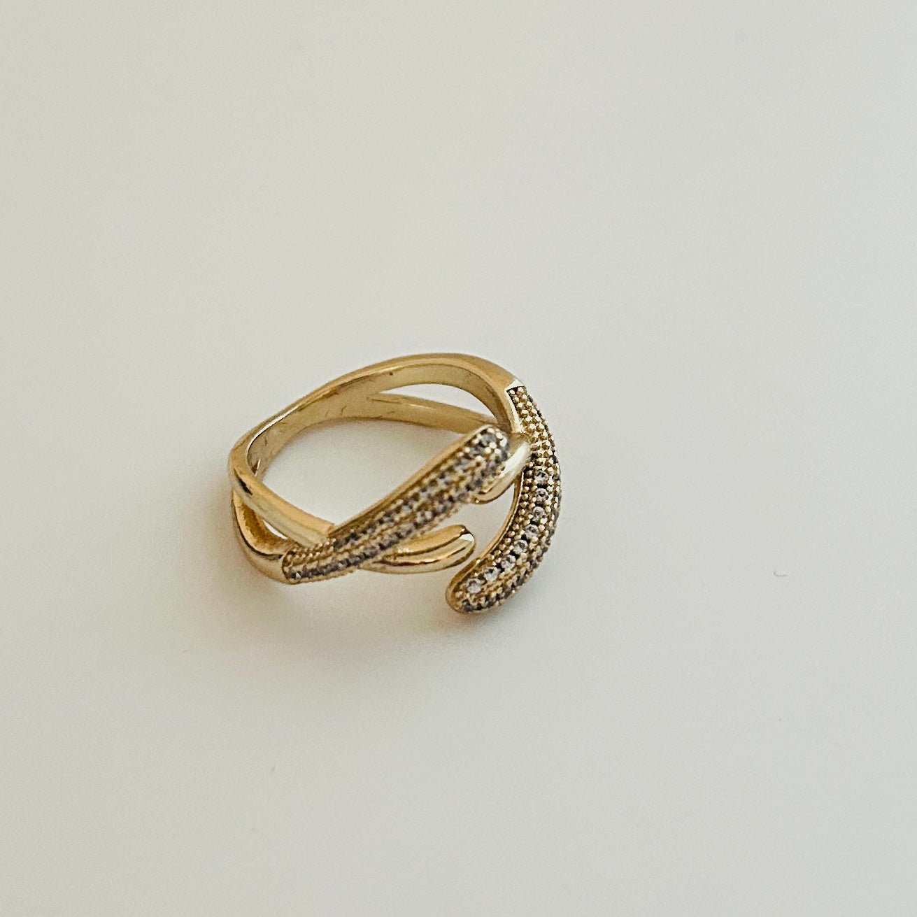 Sophisticated Gold-Plated Ring with Curved Design and Pavé Cubic Zirconia Accents